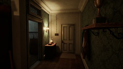 Dormitory hallway with green damask wallpaper, a wall lamp and a closed door