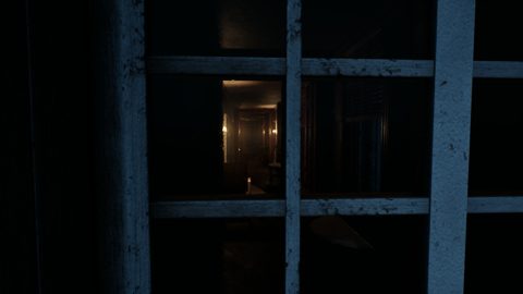 A dimly lit corridor seen through a window frame